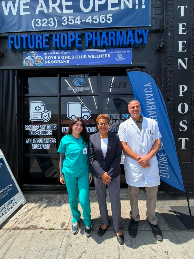 Future Hope Pharmacy storefront in Los Angeles — staff and a visiting community leader outside the shop, which partners with Boys & Girls Club wellness programs.